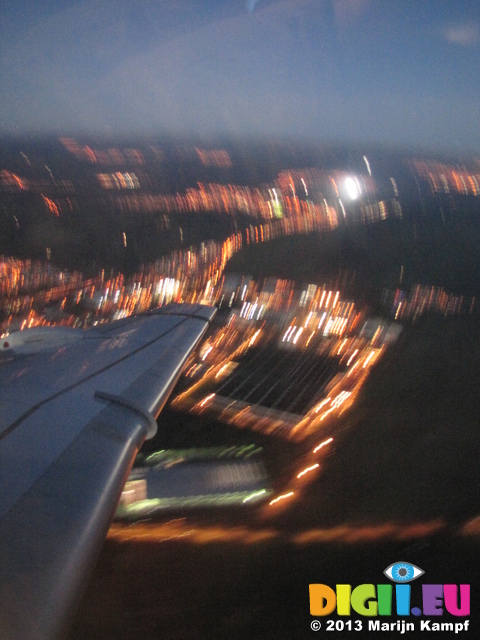 SX32639 Airplane wing over town lights